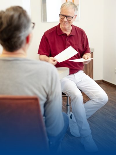 A doctor talks to his patient in a BP® practice outfit.