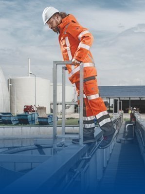 A man on a roof wears multi-standard arc fault protection clothing.