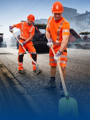 Two road builders are on a construction site and are wearing BProtected work clothing.