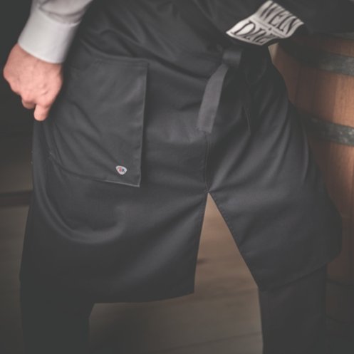 A waiter wears an apron.
