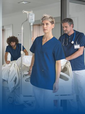 Hospital staff pushing a hospital bed with matching work uniform.