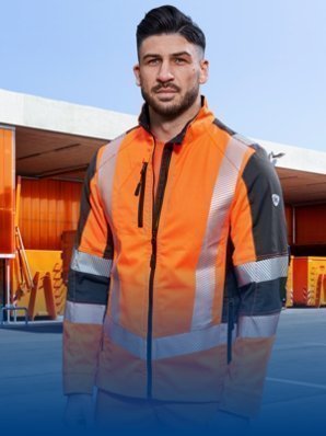 A waste management employee wears an orange work jacket.