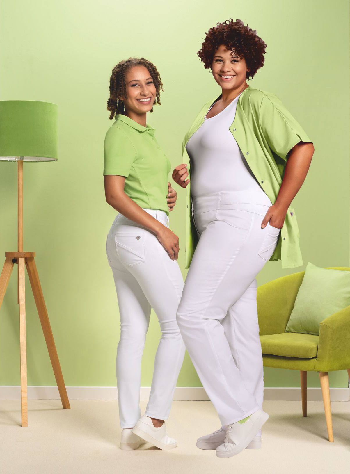 Two carers pose in white work trousers.