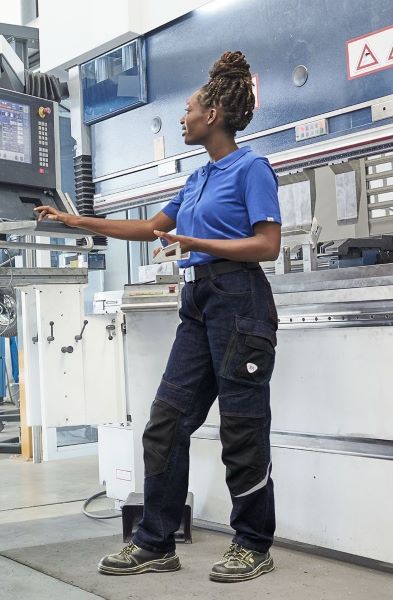 A woman wears a pair of workwear jeans